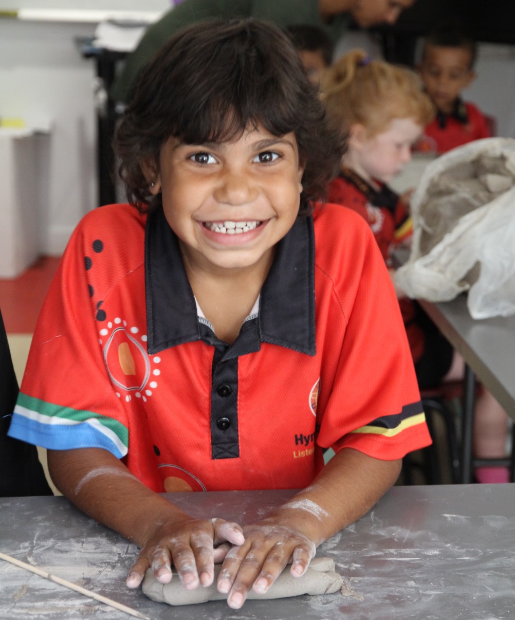 Esther making a snake from clay.